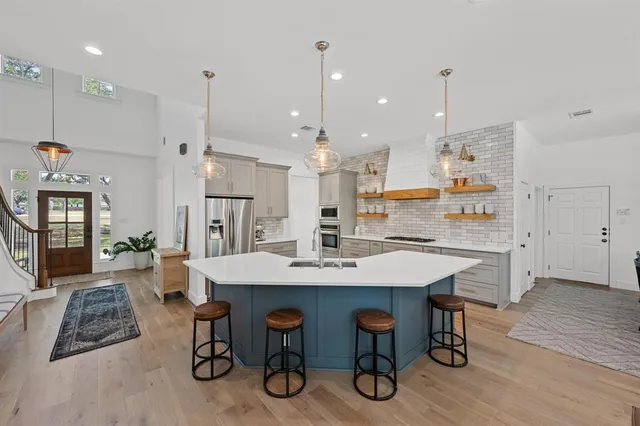 a large kitchen with a table and chairs