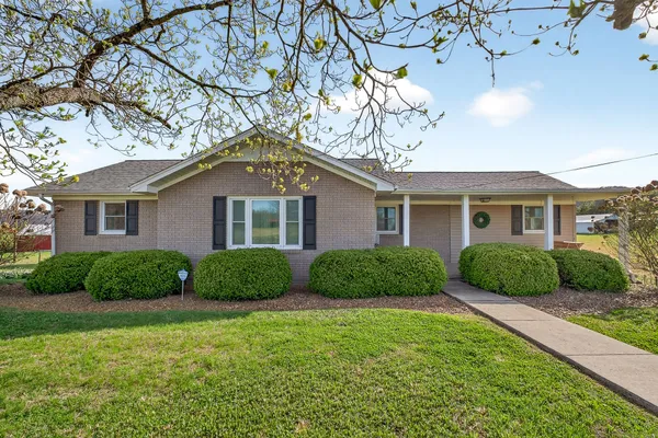 a view of a house next to a yard