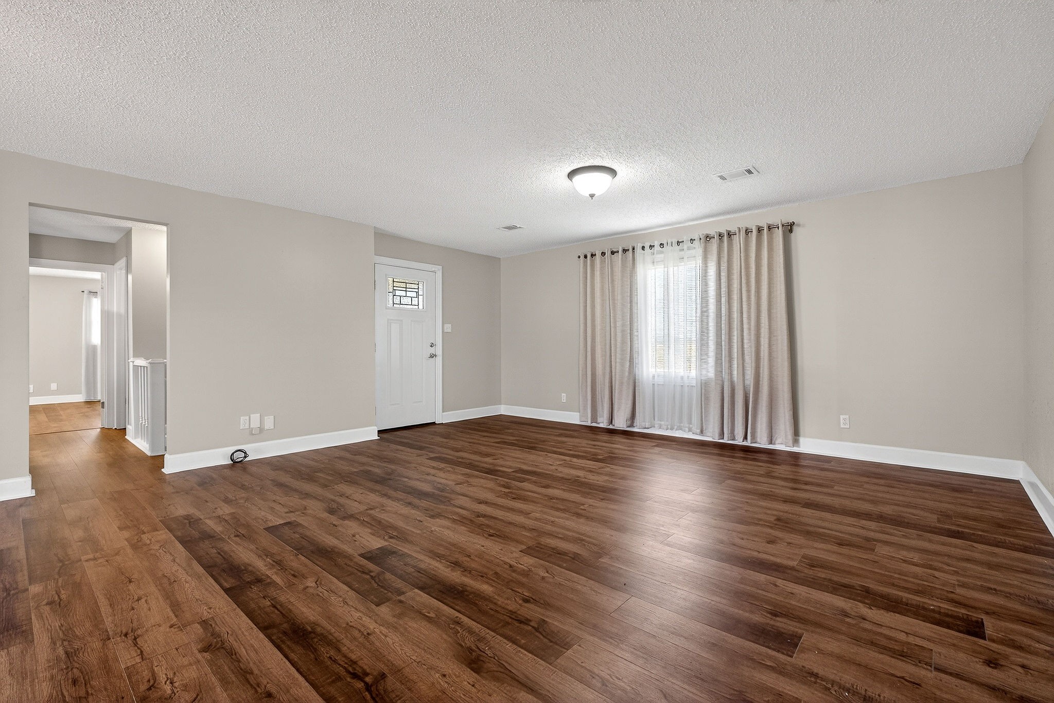 1003 Hodges Ferry Road Sparta, TN 38583 - Photo 11 of 49 a view of an empty room with wooden floor and a window