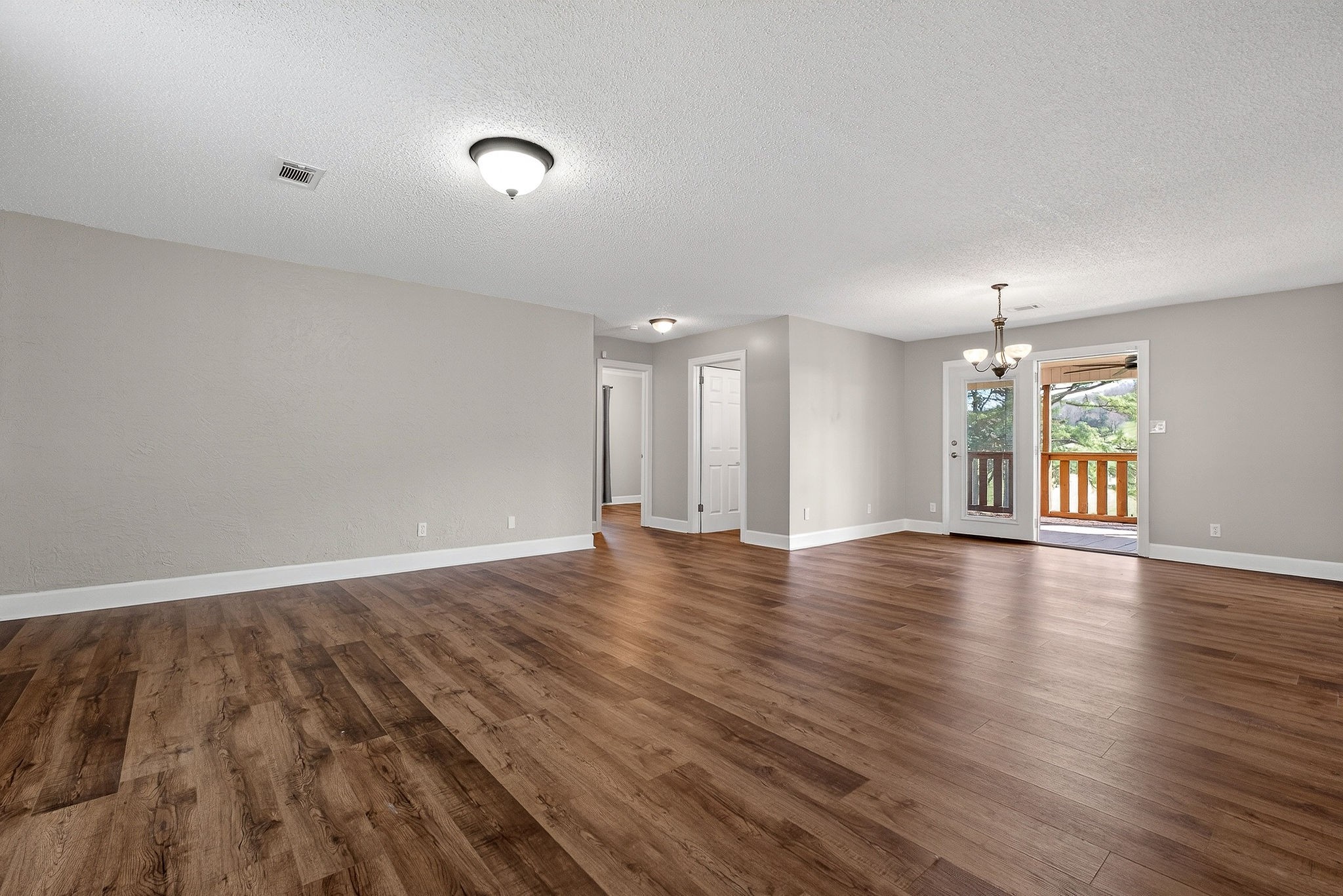 1003 Hodges Ferry Road Sparta, TN 38583 - Photo 13 of 49 an empty room with wooden floor and windows