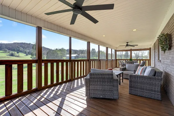a living room with couches chairs and a large window