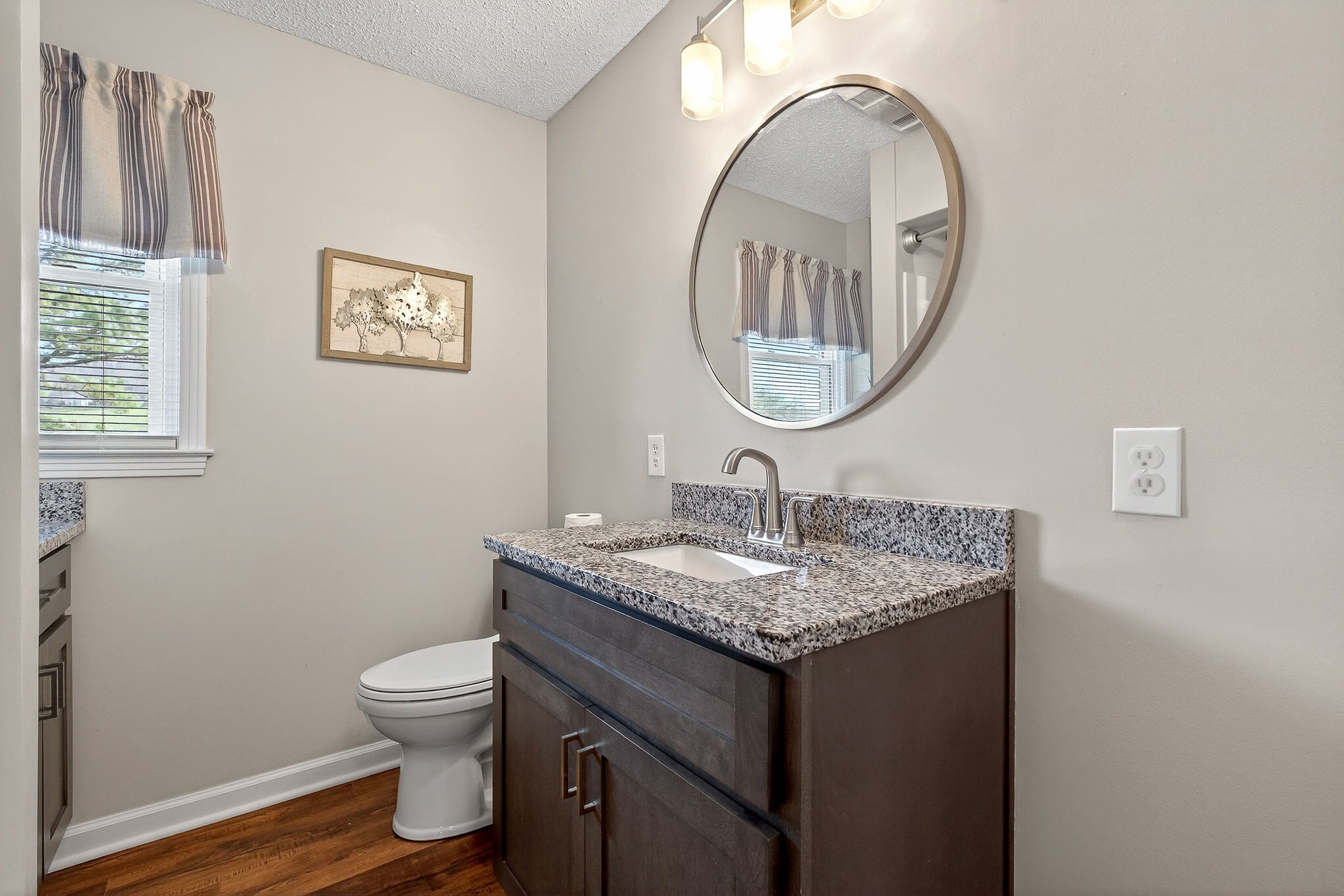 1003 Hodges Ferry Road Sparta, TN 38583 - Photo 40 of 49 a bathroom with a toilet a sink and a mirror