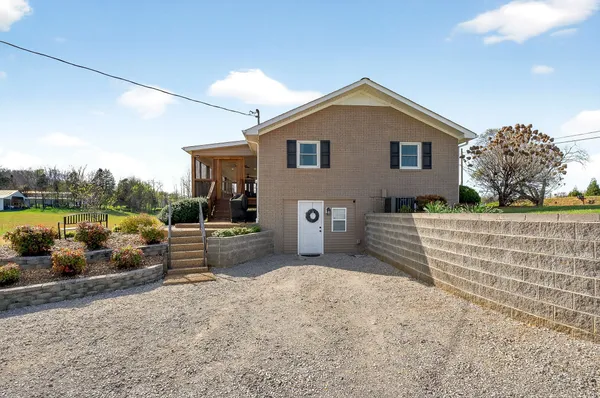 a view of a house with backyard and sitting area