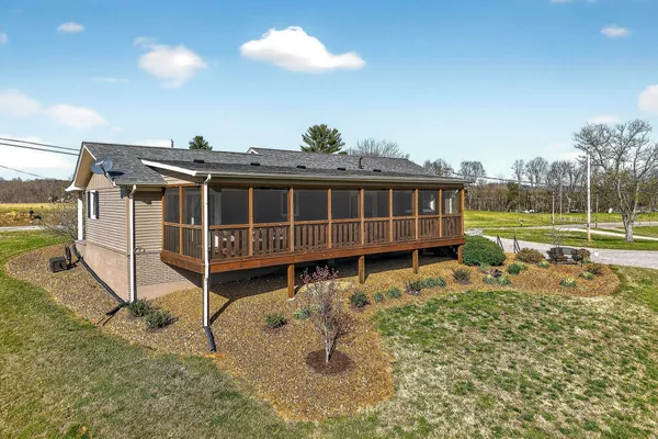 a view of a house with a backyard and a garden