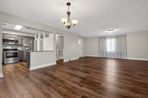 a view of a kitchen with wooden floor and a kitchen