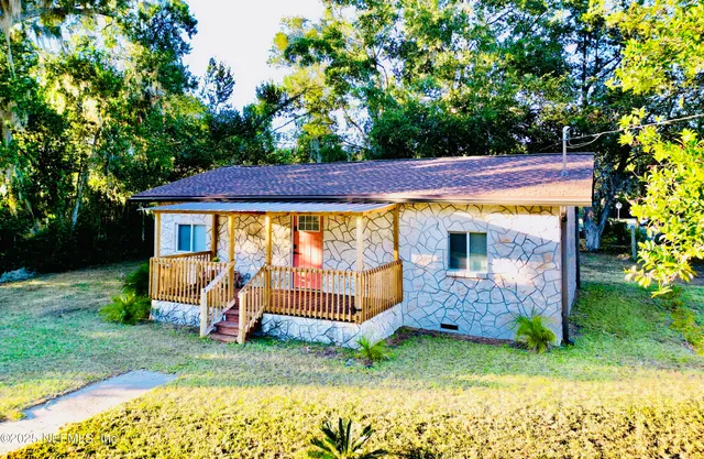 a view of a backyard with a garden and entertaining space
