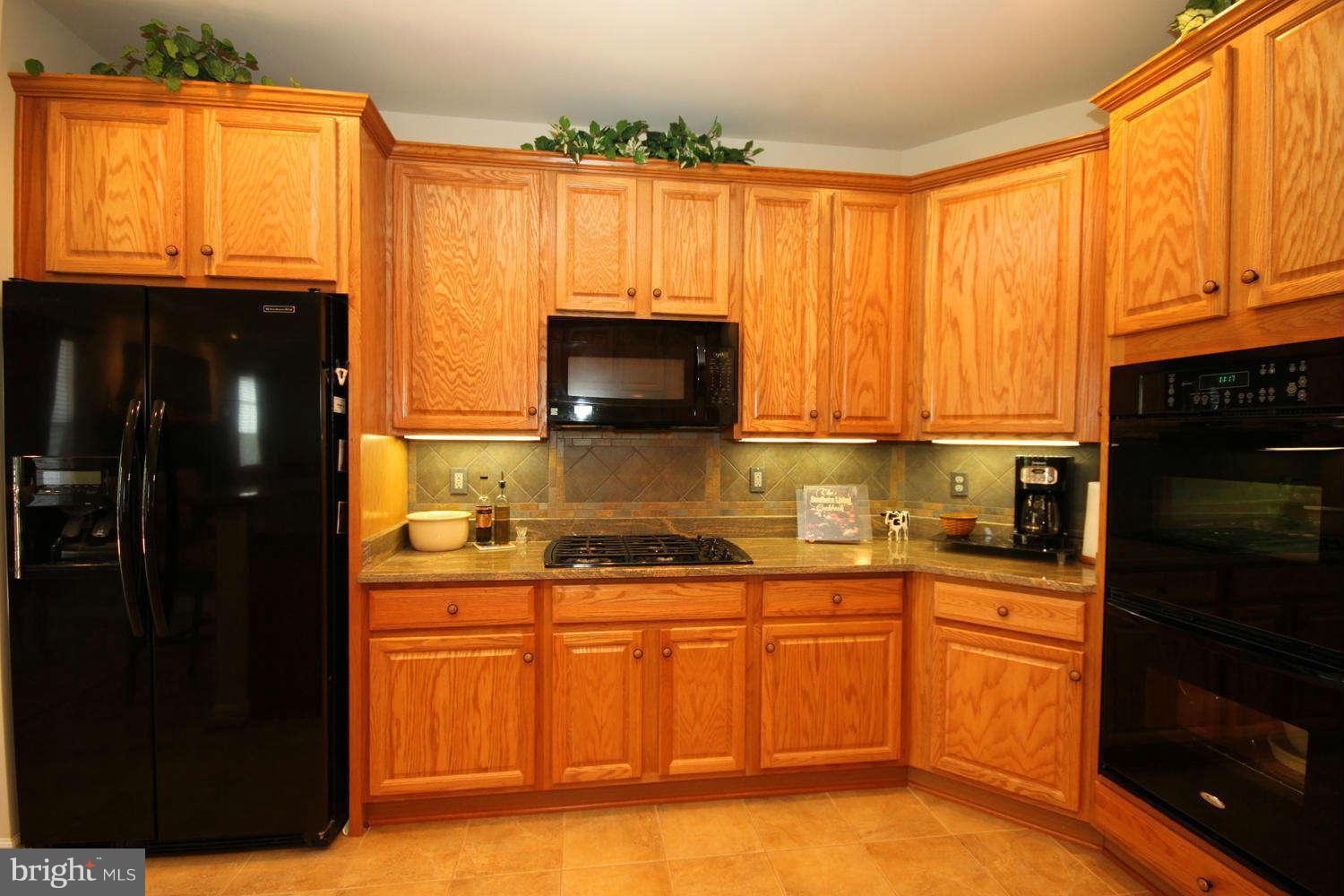 2 Sumantown Road Middletown, MD 21769 - Photo 11 of 30 a kitchen with stainless steel appliances granite countertop a stove a sink dishwasher and a microwave oven with cabinets
