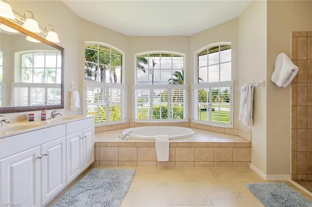 a spacious bathroom with sink shower and bathtub