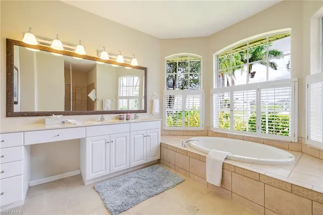 a large bathroom with a large tub sink and double vanity