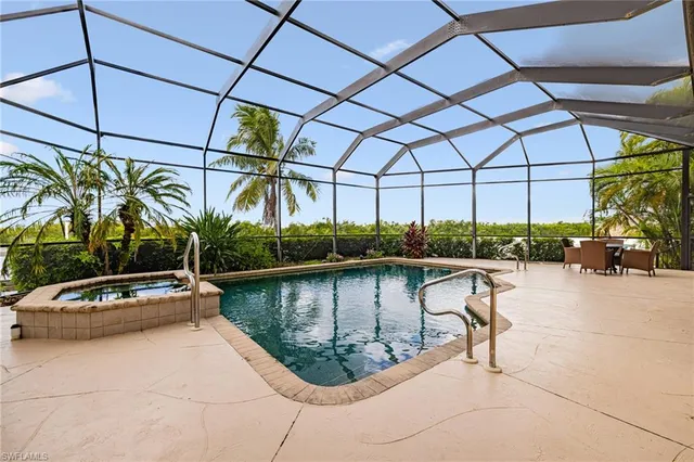 a view of swimming pool with outdoor seating