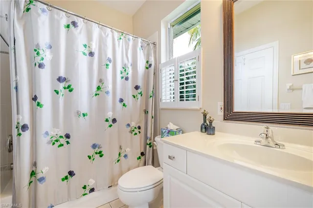 a bathroom with a granite countertop bathtub sink and toilet