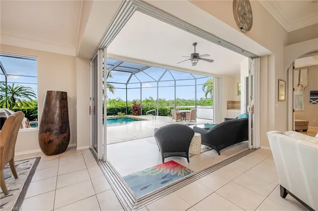 a view of living room filled with furniture and large windows