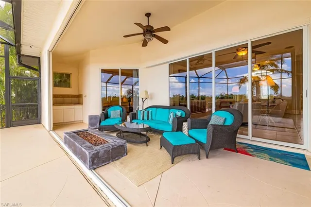 a living room with patio furniture and a potted plant