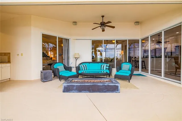 a living room with furniture a ceiling fan and a window