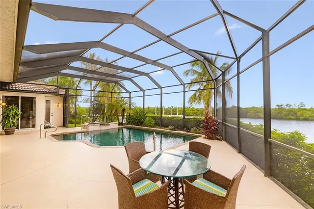 a dining room with furniture a chandelier and wooden floor