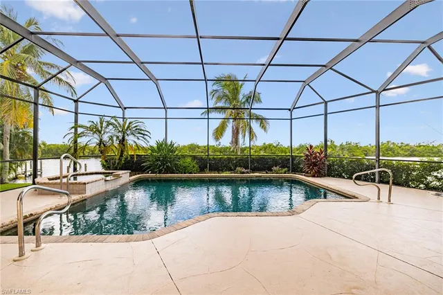 a swimming pool with outdoor seating and outdoor shower
