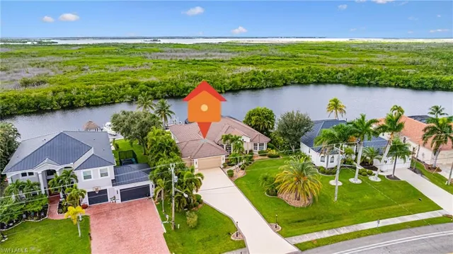 an aerial view of a house with a yard lake view and mountain view