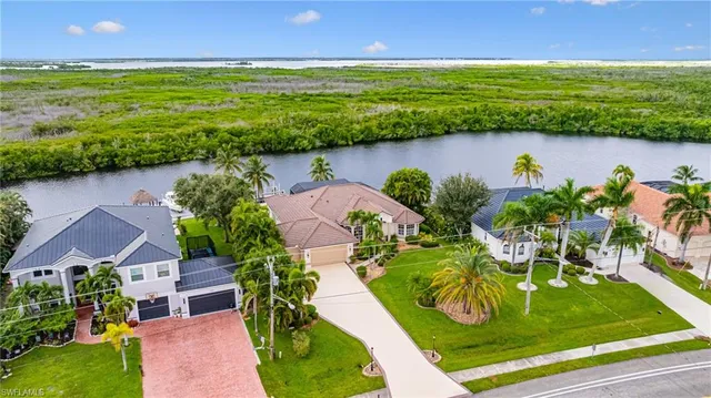 an aerial view of a house with a yard lake view and mountain view