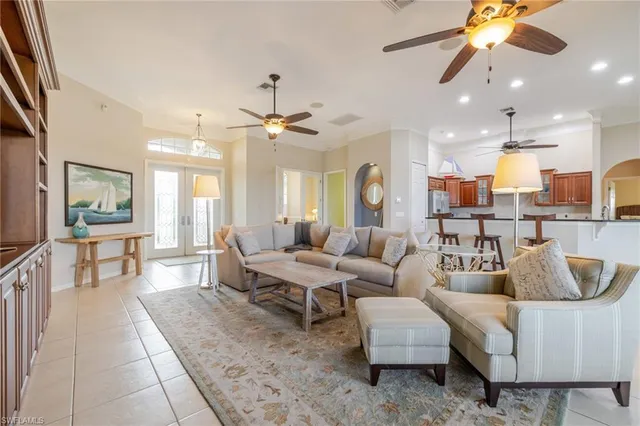 a living room with furniture kitchen view and a large window
