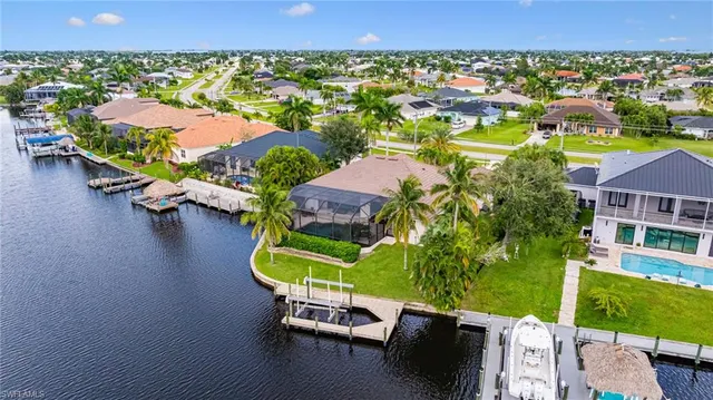 an aerial view of residential houses with outdoor space and swimming pool