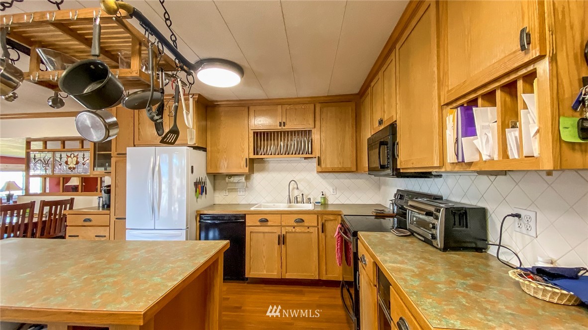 1787 East Lind Ralston Road Ritzville, WA 99169 - Photo 3 of 37 a kitchen with stainless steel appliances granite countertop a sink a stove and a refrigerator