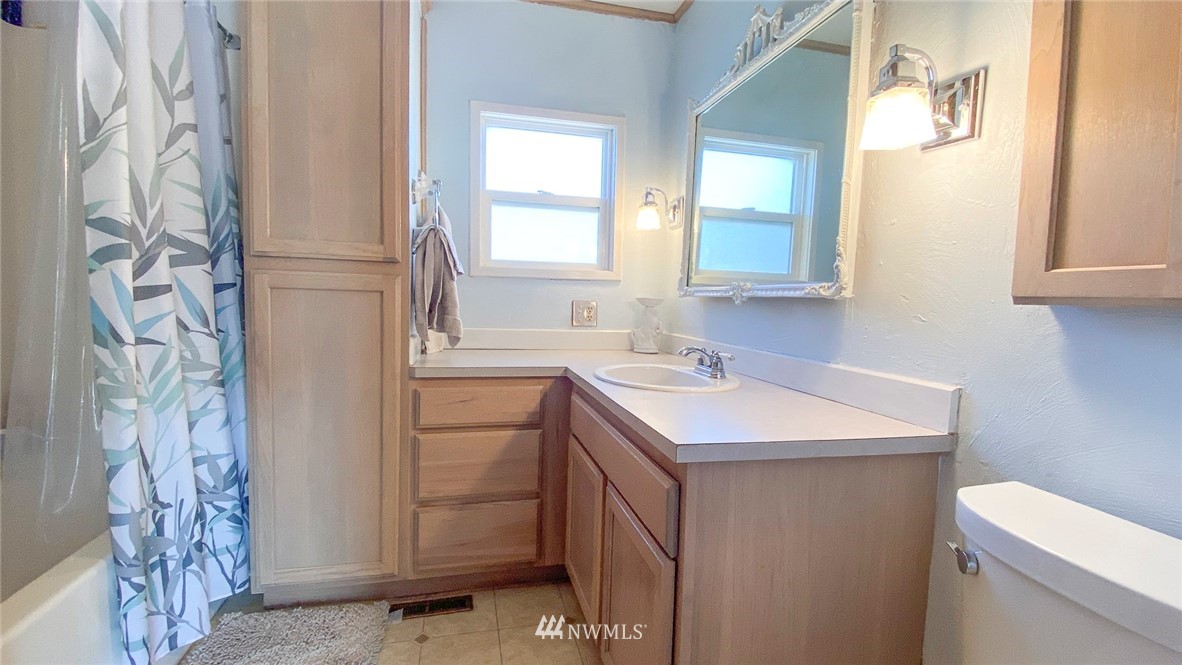 1787 East Lind Ralston Road Ritzville, WA 99169 - Photo 8 of 37 a bathroom with a sink toilet vanity and a mirror