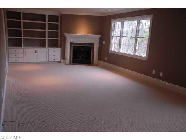 6309 Nesting Way Oak Ridge, NC 27310 - Photo 7 of 8 Other. Master bedroom with fireplace, built in cabinet and lovely tray ceiling