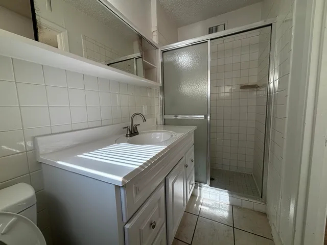 a bathroom with a shower toilet and sink