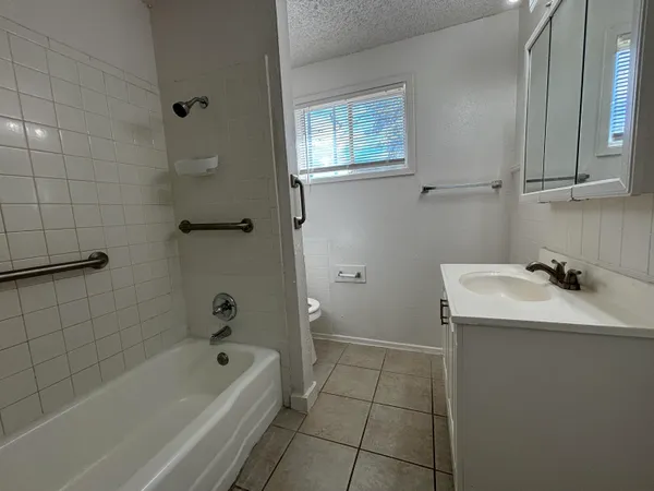 a bathroom with a sink a toilet and bathtub