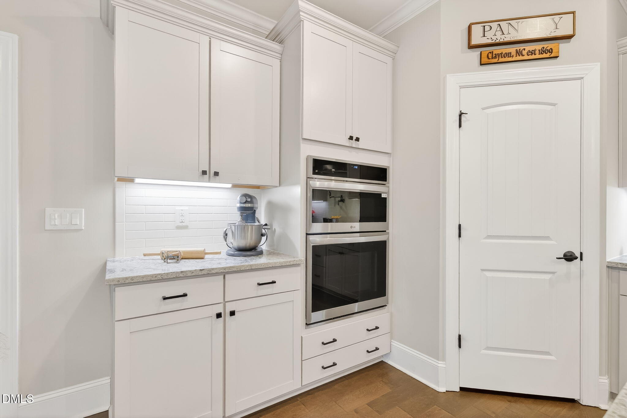 524 Dungannon Loop Clayton, NC 27520 - Photo 16 of 80 a kitchen with white cabinets and white appliances