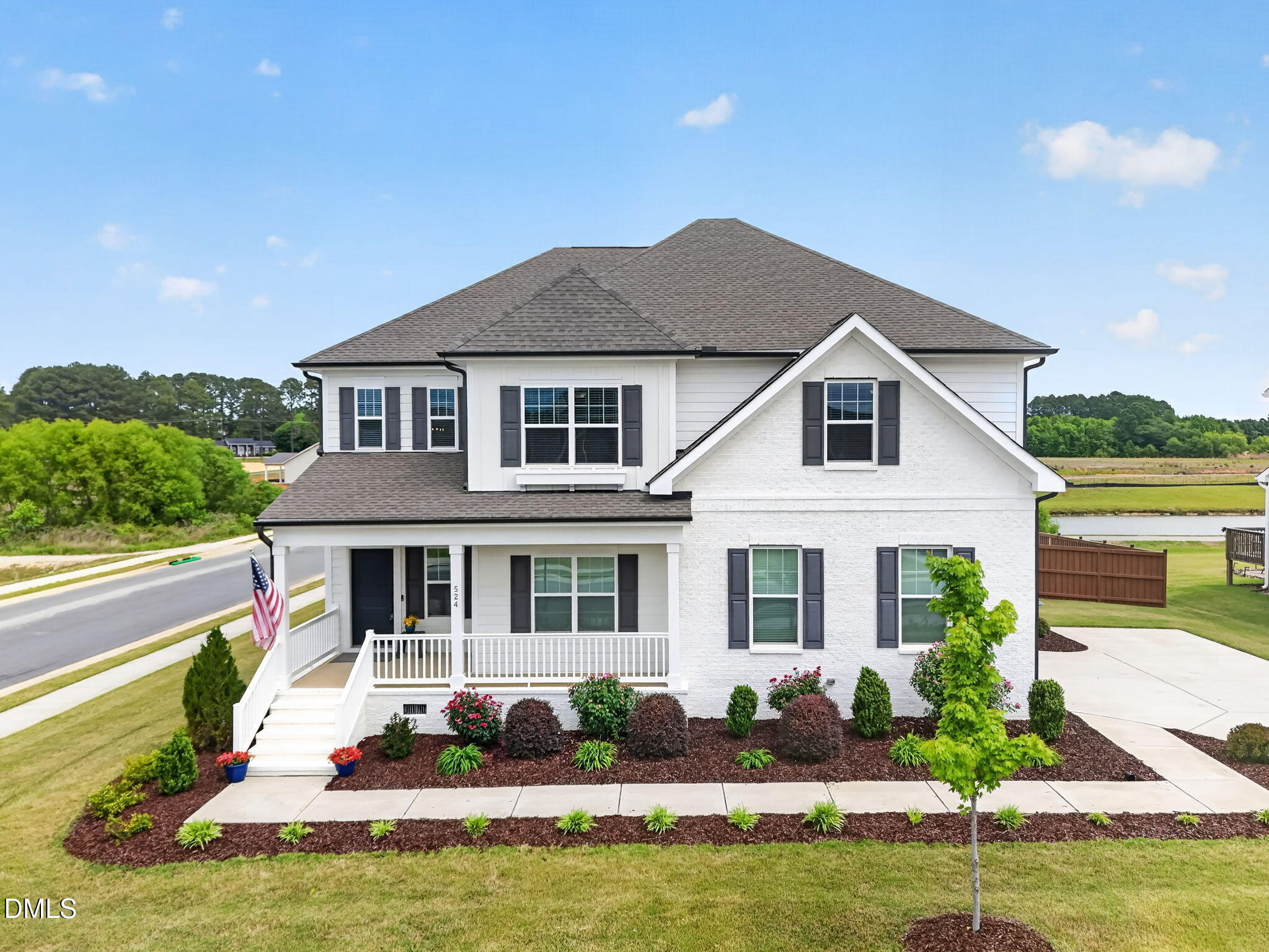 524 Dungannon Loop Clayton, NC 27520 - Photo 2 of 80 a front view of a house with a yard table and chairs
