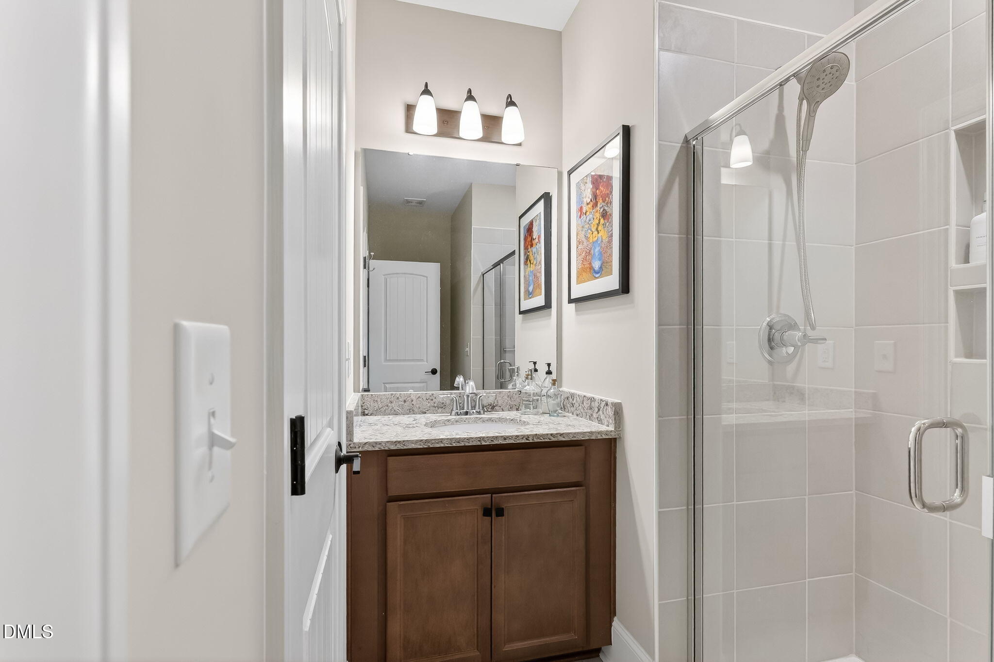 524 Dungannon Loop Clayton, NC 27520 - Photo 24 of 80 a bathroom with a granite countertop sink a mirror and shower