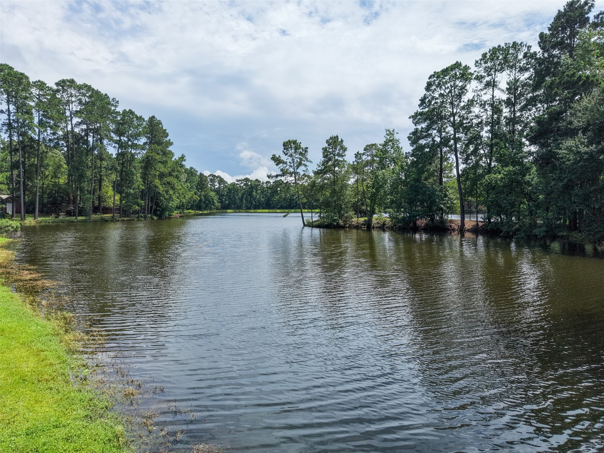 6387 Oak Knoll Road Montgomery, TX 77316 - Photo 26 of 30 a view of a lake with houses in the back