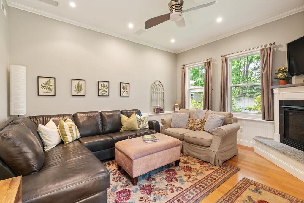 15 Millbrook Road Beverly, MA 01915 - Photo 11 of 32 a living room with furniture flat screen tv and a fireplace