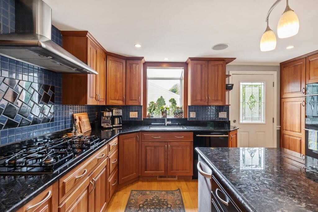 15 Millbrook Road Beverly, MA 01915 - Photo 7 of 32 a kitchen with stainless steel appliances granite countertop a stove a sink and a microwave