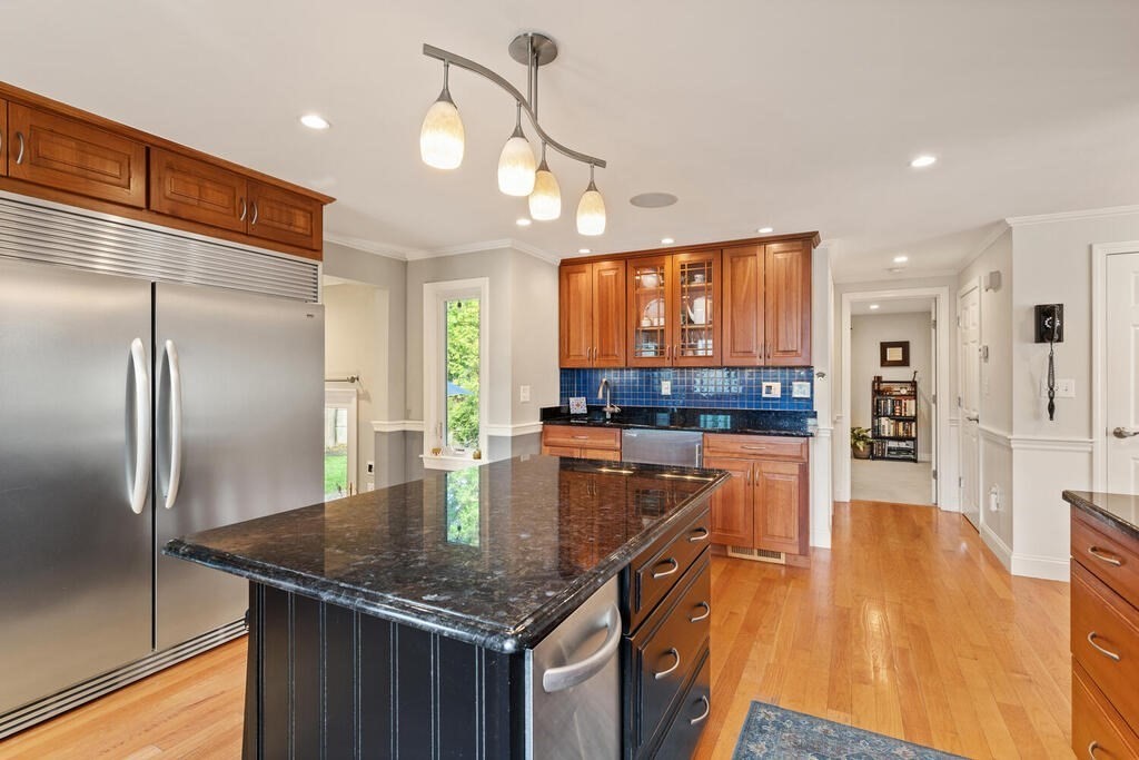 15 Millbrook Road Beverly, MA 01915 - Photo 8 of 32 a kitchen with stainless steel appliances granite countertop a kitchen island a stove a refrigerator a oven and a sink