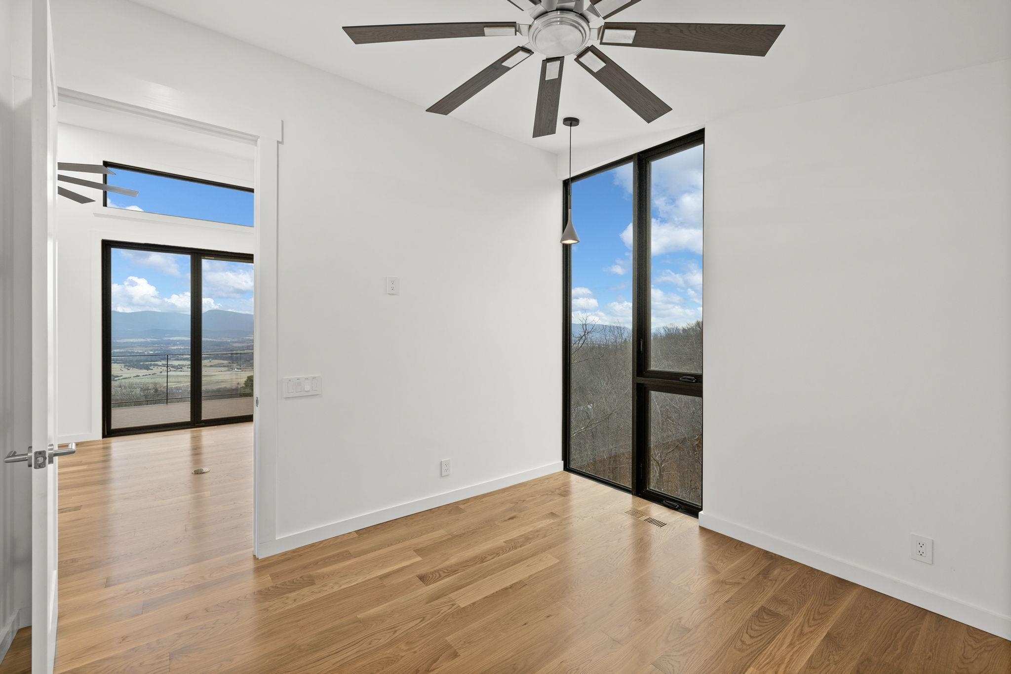 132 Holly Hl Road Luray, VA 22835 - Photo 21 of 69 an empty room view with a ceiling fan and wooden floor