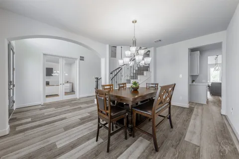a kitchen with kitchen island a stove a table and chairs in it