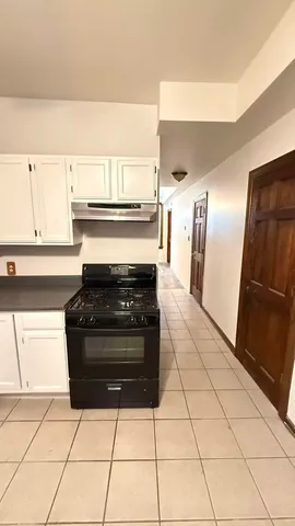 a kitchen with a stove and a refrigerator