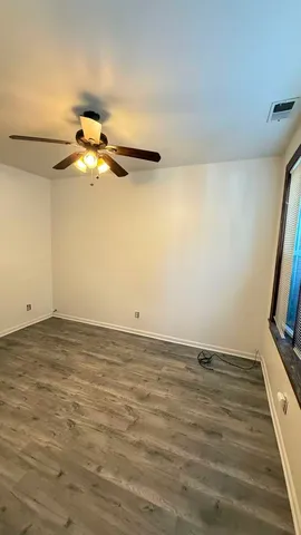 a view of a room with wooden floor