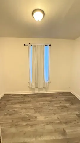 a view of wooden floor and brick walls