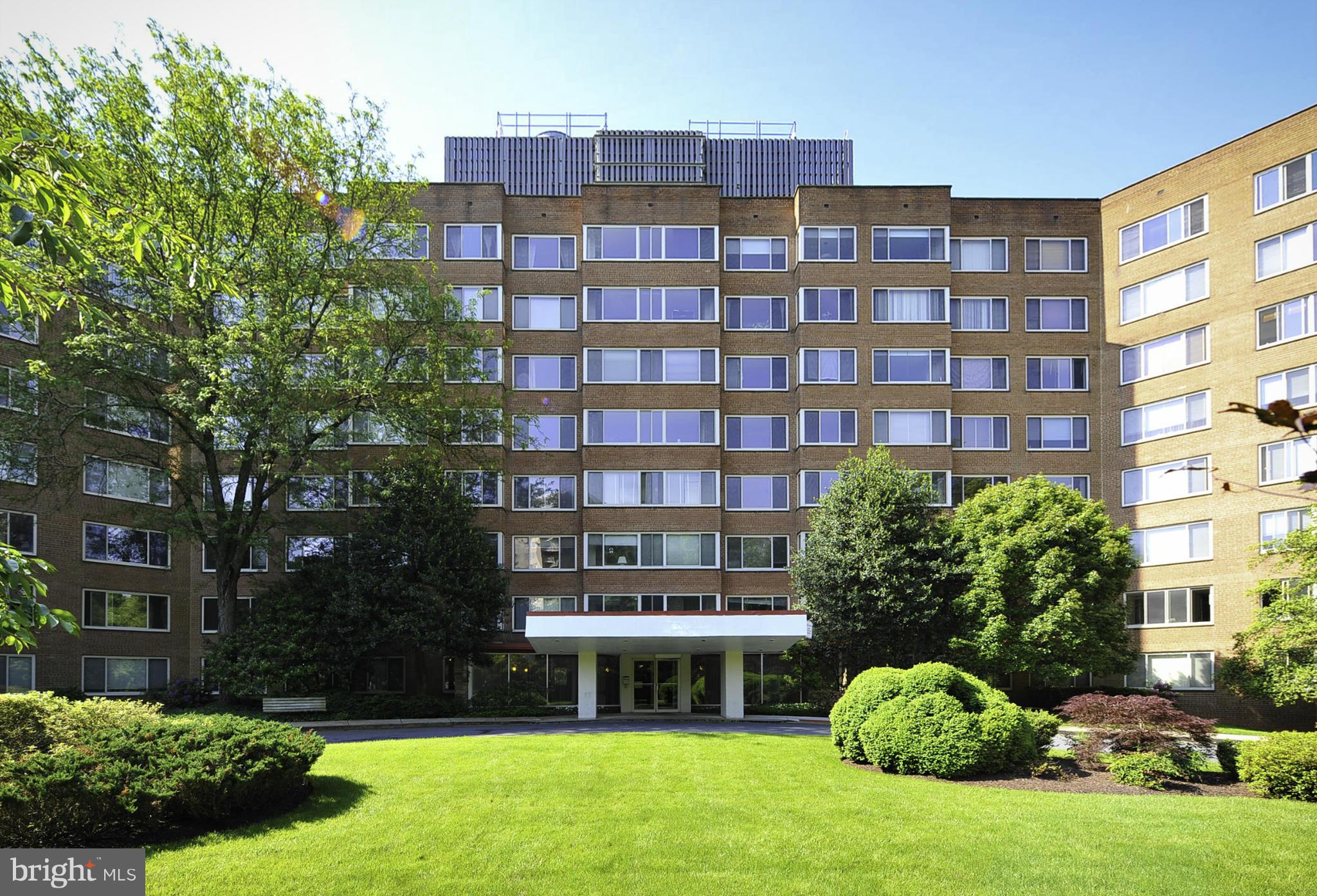 4000 Tunlaw Road Northwest, Unit 1026 Washington, DC 20007 - Photo 1 of 15 a front view of a building with a garden