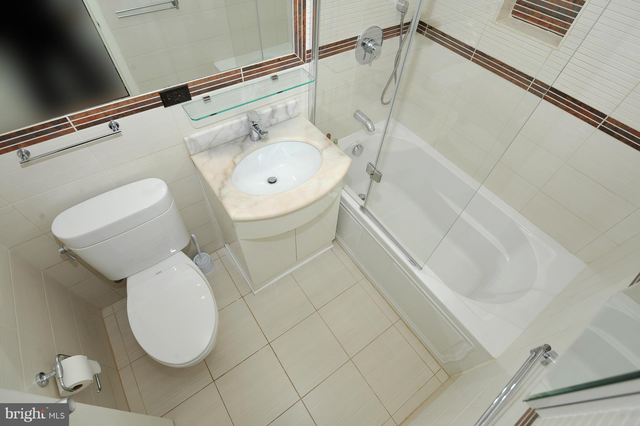 4000 Tunlaw Road Northwest, Unit 1026 Washington, DC 20007 - Photo 11 of 15 a bathroom with a toilet and a sink