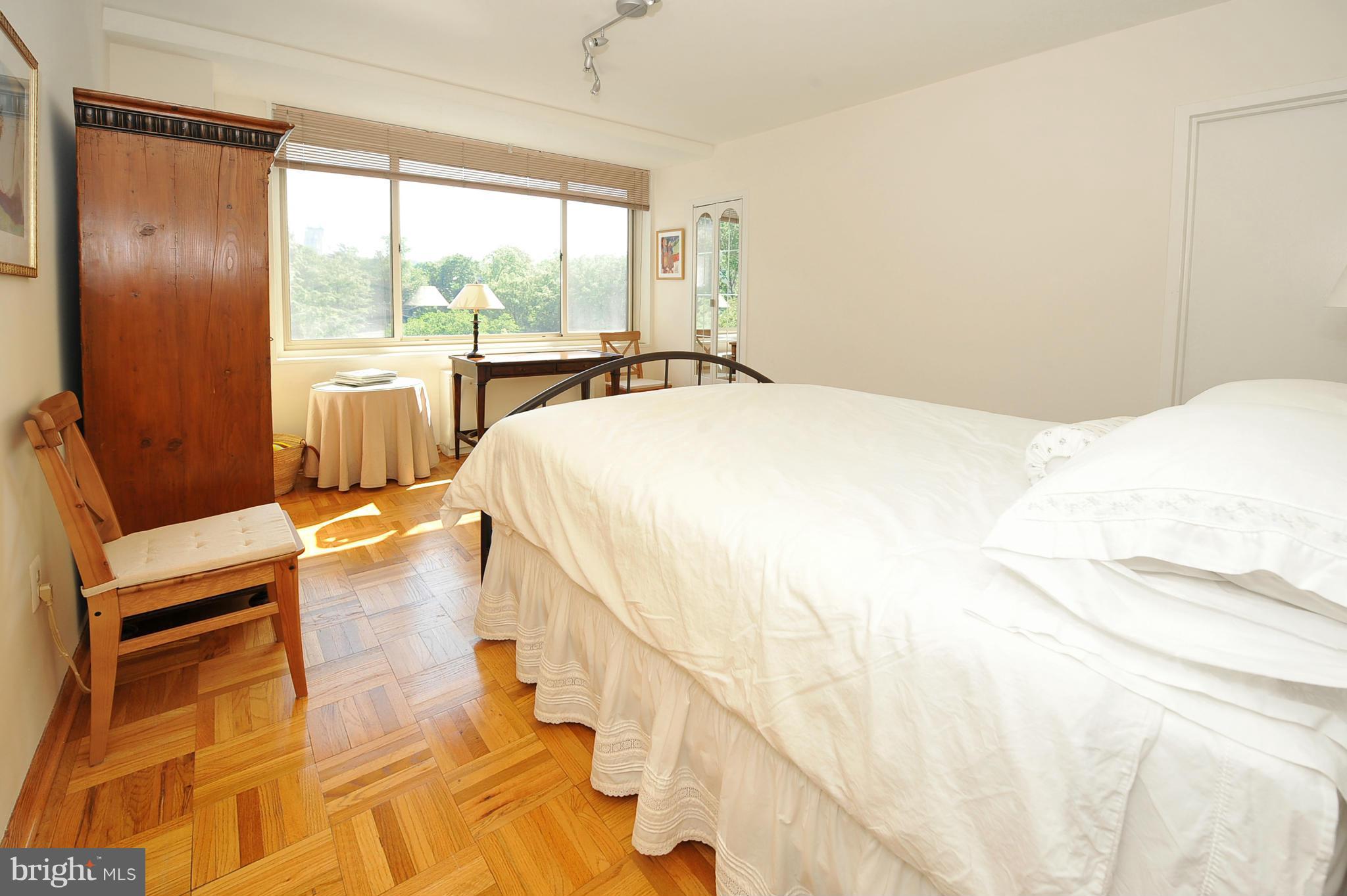 4000 Tunlaw Road Northwest, Unit 1026 Washington, DC 20007 - Photo 13 of 15 a bedroom with a bed and large windows