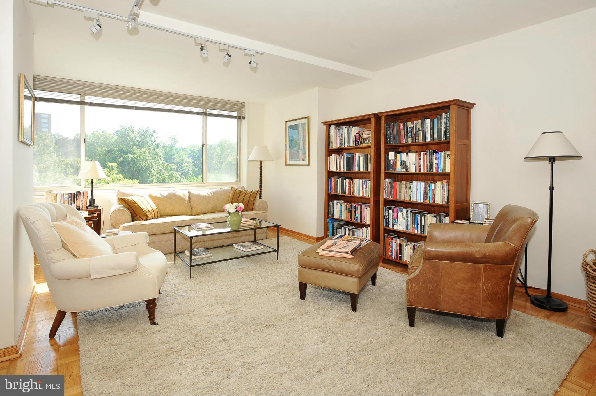 4000 Tunlaw Road Northwest, Unit 1026 Washington, DC 20007 - Photo 3 of 15 a living room with furniture and a large window
