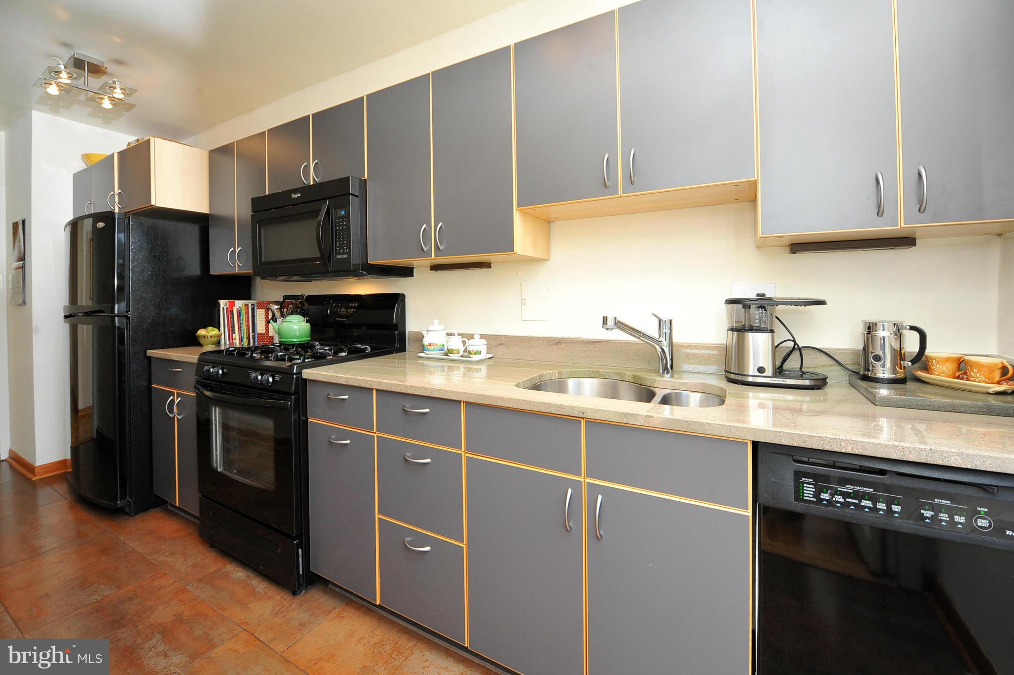 4000 Tunlaw Road Northwest, Unit 1026 Washington, DC 20007 - Photo 6 of 15 a kitchen with a sink a stove and refrigerator