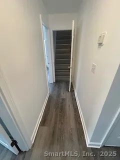 a view of a hallway with wooden floor and staircase