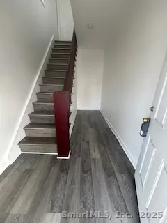 a view of entryway and hall with wooden floor