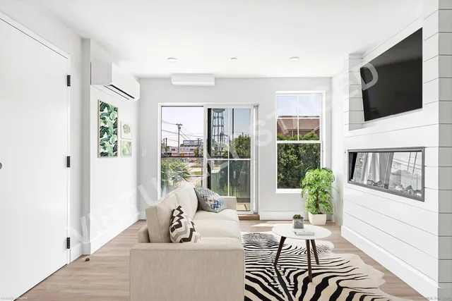 a living room with furniture tv and a flat screen tv