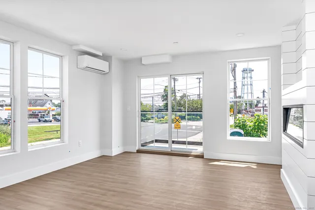 a view of room with window and wooden floor
